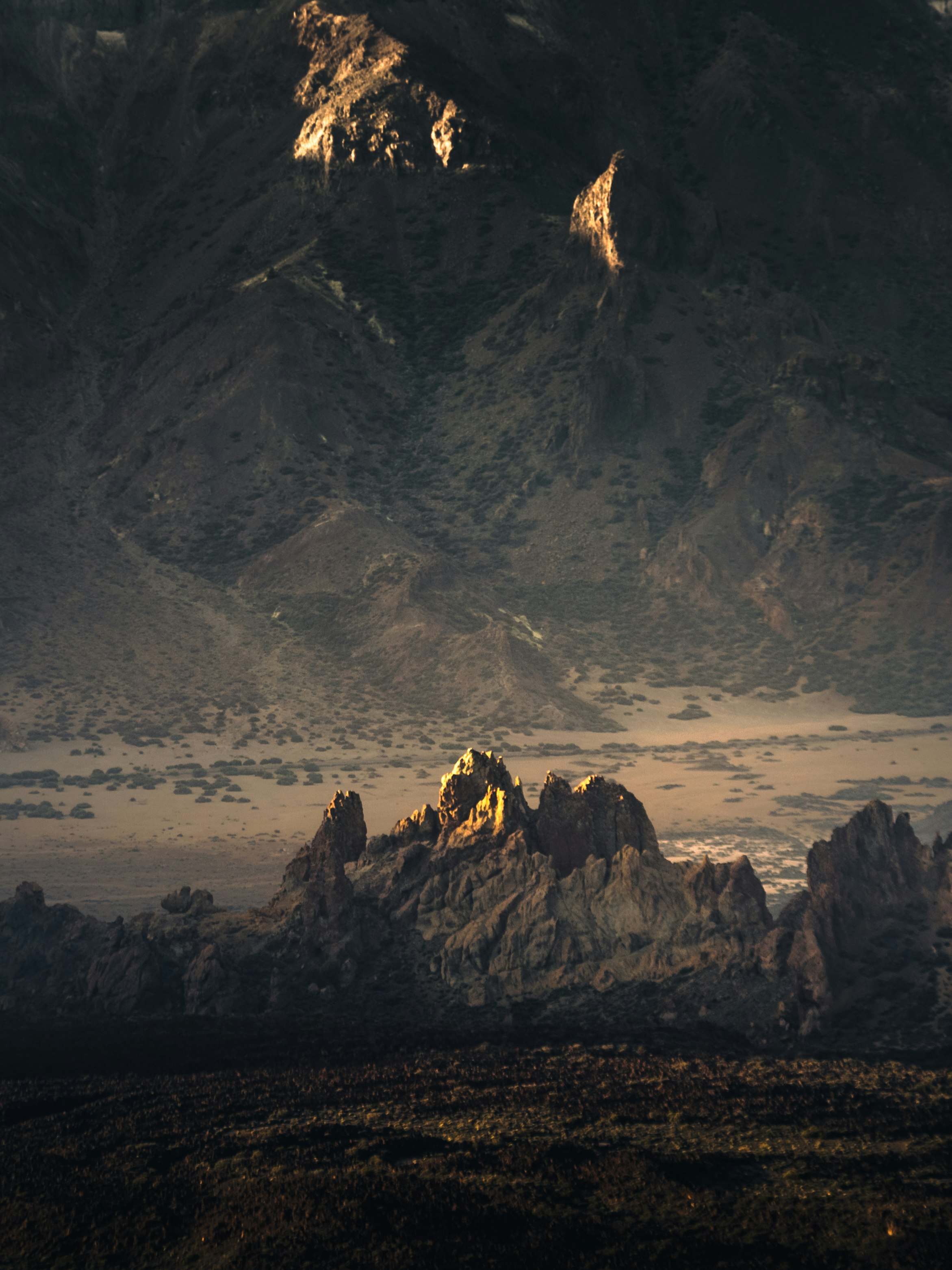 silhouette of people on rock formation during daytime